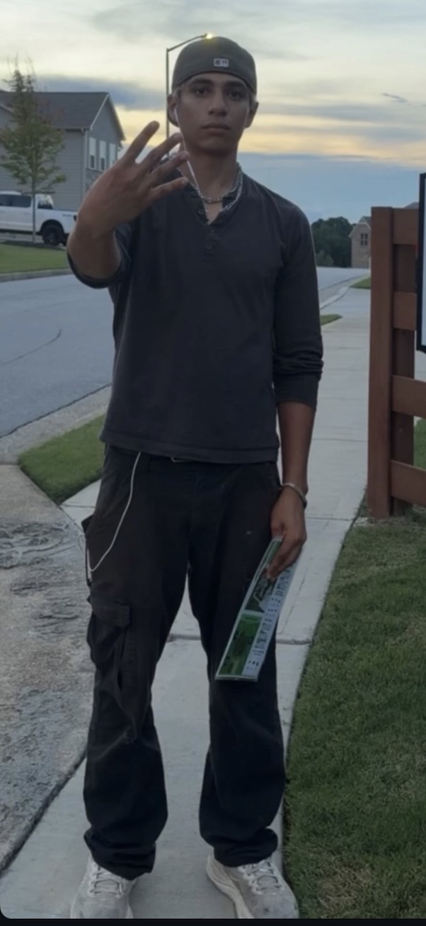 Manny on a neighborhood route at dusk with literature in hand